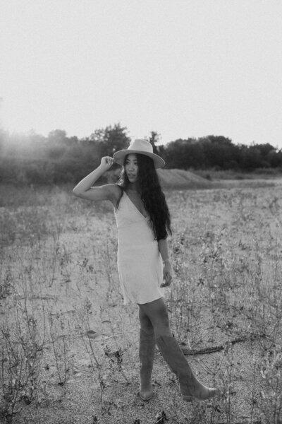 Model outside at sunset, a black and white photo of her dancing in a field