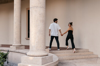 engagement photos in gainesville fl couple walking up stairs holding hands