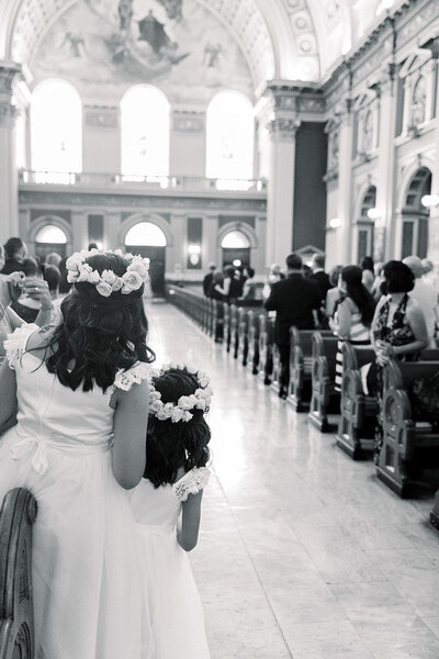 flower girls looking at church entrance in anticipation for bride