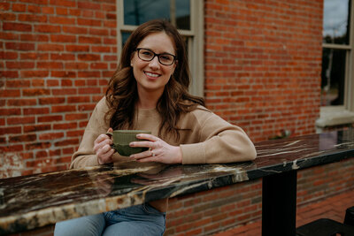 Rose Benedict sitting on couch