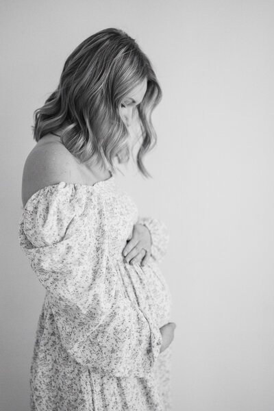 a pregnant woman holding her baby bump