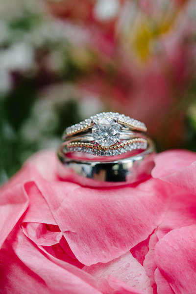 closeup of wedding ring sitting on top of a peoni
