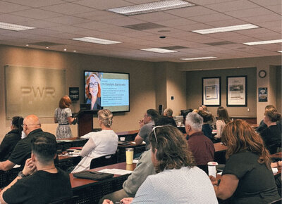 Carolynn Santaniello leading a live training session at PWR, educating agents on real estate contracts, industry updates, and best practices with clarity and confidence.