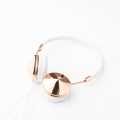 white and gold headphones on white background