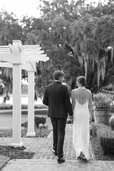 Black and White of Bride and Groom Kissing at Wedding Reception Photo