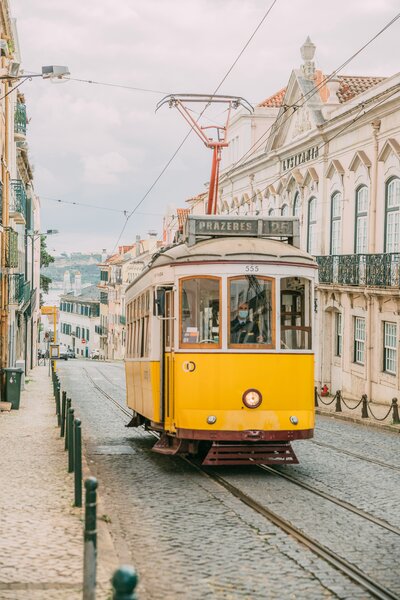 Tram passing through historic streets of Lisbon, Portugal