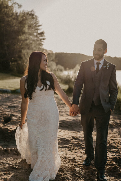 A dreamy sunset portrait of the bride and groom at the lakeside.
