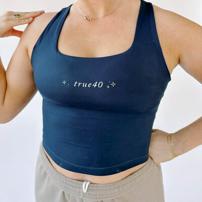 Woman wearing a square neck navy athletic tank top
