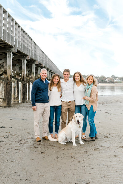 family with dog on beach