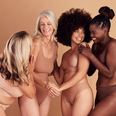 Three healthy women of different sizes smiling, promoting body positivity and inclusivity in wellness, featured in Muse Studio’s social media strategy and branding efforts.