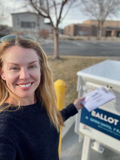 A picture of Tricia mailing a ballot