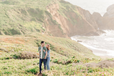 couple hugging on carmel cliffside engagement photos - carmel engagement photographer