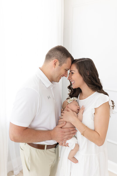 Couple holding a newborn in studio