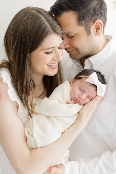 Parents holding newborn at in home lifestyle newborn session in New York City