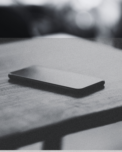 A phone lying face down on a table, symbolizing the silence and betrayal explored in the “They Lied Again” Learning Path from CPTSD Medicine.