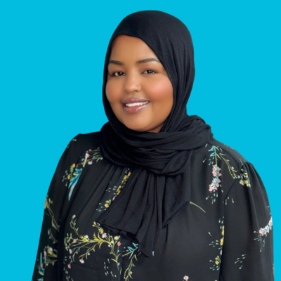 Woman wearing a Black hijab and black floral shirt who is the Care Coordinator at Move Forward