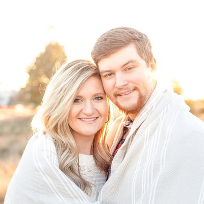 engaged couple wrapped in blanket