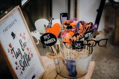 wedding poto booth props on sticks in a bucket