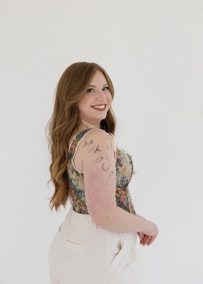 Holly, co-founder and lead hairstylist at Klover Beauty, smiling at the camera during a professional brand photoshoot in Maryland.