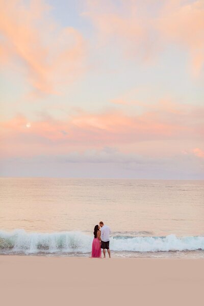 full moon rises over maui during a sunrise love and water photoshoot