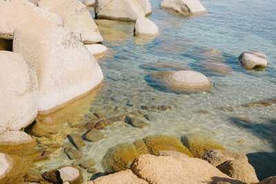 Sunlit boulders visible beneath clear water—symbolizing an easy, transparent path to the right resource.