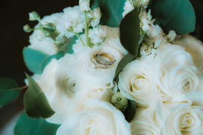 wedding bands on top of the bridal bouquet