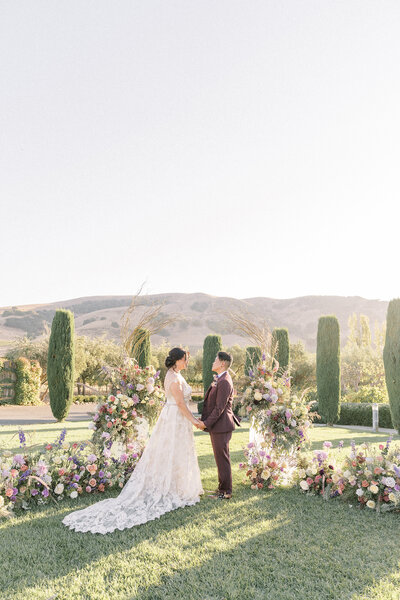 an lgbtq couple stands at their ceremony, holding hands during their intimate Viansa Winery sonoma wedding.