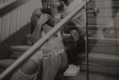 Engagement session with couple cozying up on some steps in the city. Detail photo