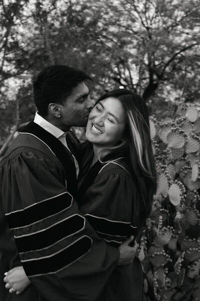 Engaged couple holding hands and smiling during golden hour photo session.