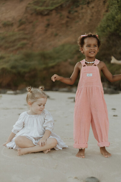 Two girl cousins playing on Chinamens Beach in Evans Head NSW