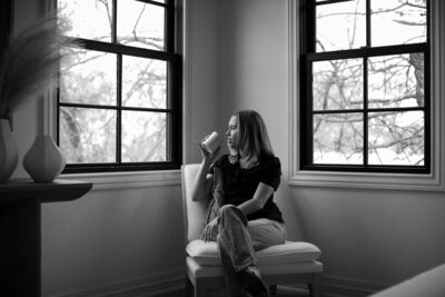 black and white photo woman drinking coffee in chari