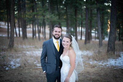 Bride and groom smiling outside