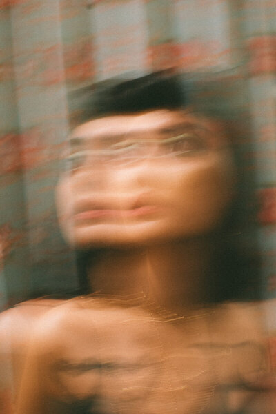 Image of a woman that is blurred. Representing the feeling of being overwhelmed which can be reduced with therapy for stress in Brooklyn or New York, NY. Out Manhattan therapists will help you with stress management today.