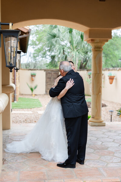 bride and groom kiss in front of horses at ranch