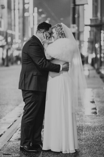 A couple posing in their wedding attire on Granville Street in Vancouver, BC.