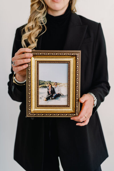 photographer holding a framed picture