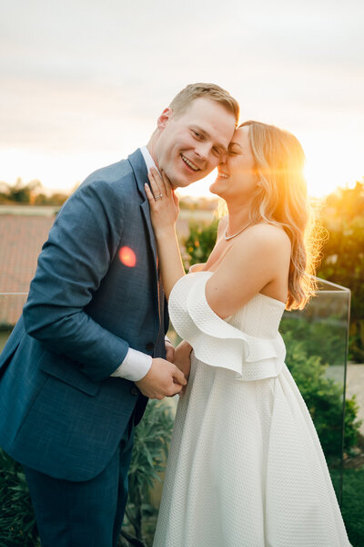 bride and groom embracing and smiling