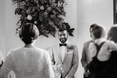 Artistic wedding photographer in Melbourne captures the groom's awestruck expression as he sees his bride walking down the aisle at The Craft & Co in Collingwood.