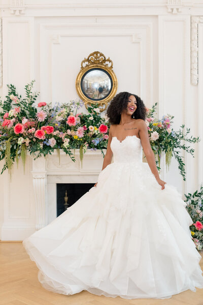 Bride twirling her dress in front of a fireplace at DAR Constitution Hall in Washington, DC. Taken by DC Wedding Photographer Bethany Aubre Photography.