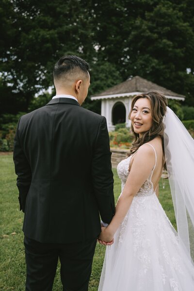 Bride and groom walking on elegant venue lawn