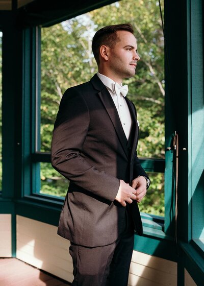 Groom getting ready for Stowe Vermont Wedding captured by Wedding photographer
