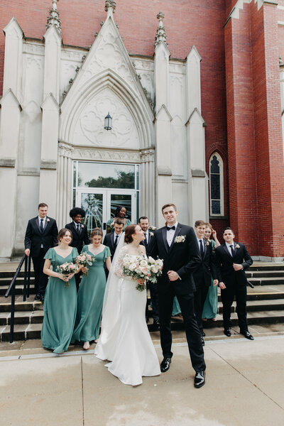 Wedding photography by Promani Weddings, featuring a decorated venue with couple portraits and floral arrangements.