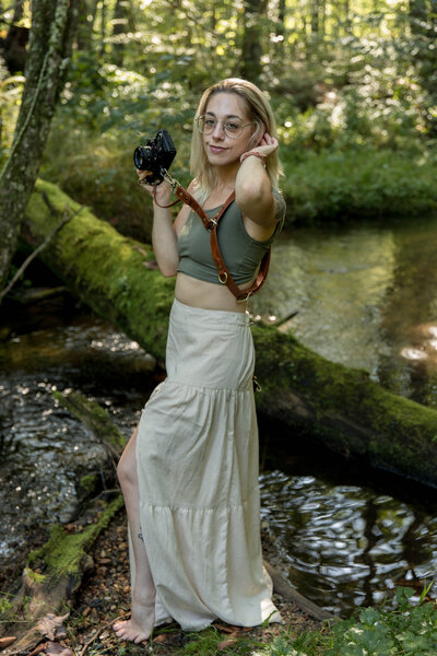 woman holding canon digital and film cameras