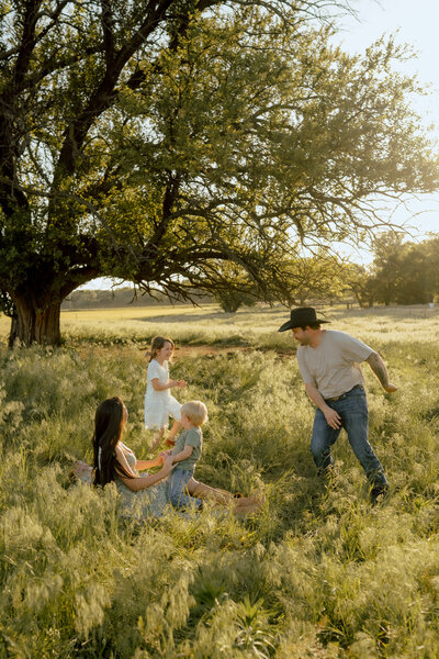 family playing in a field together