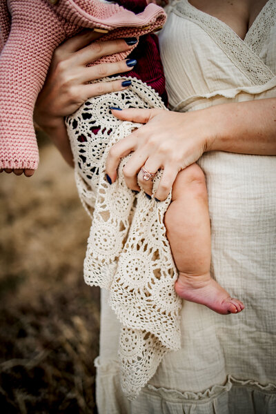 baby legs in moms embrace in Mckinney texas