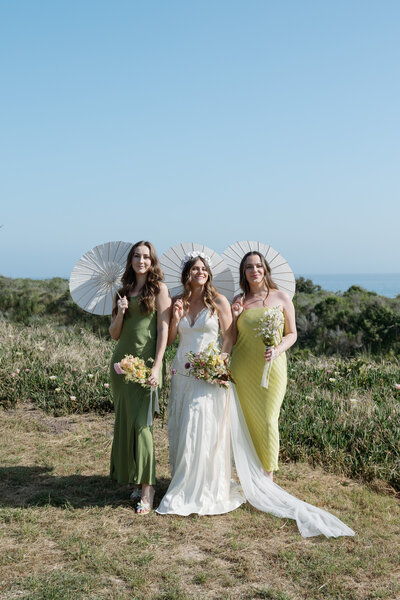 Bridesmaids posing for a photo together on the coast of La Jolla in California.