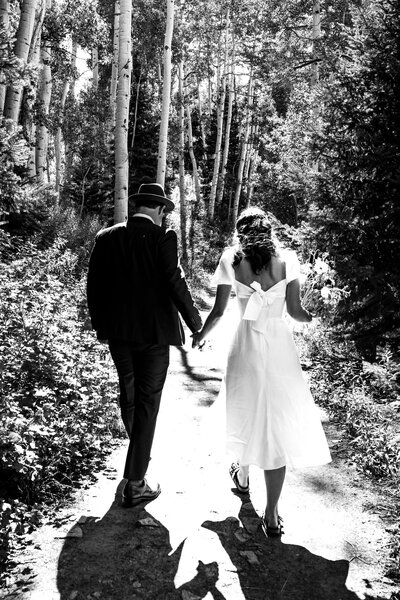 A beautiful black and white of a couple holding hands, during their elopement on the trails in Aspen, Colorado,