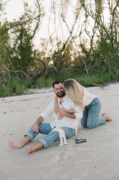 Couple kissing on beach taken by engagement photography florida