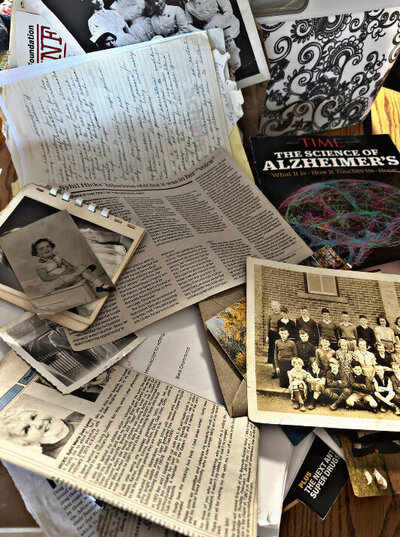 A pile of old pictures, letters, and newspaper clippings