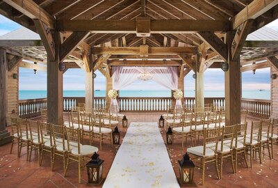 gold chairs for wedding facing water